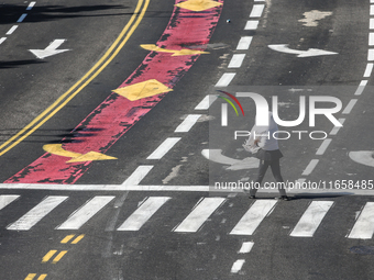 A person walks on a crosswalk on an empty street on Yom Kippur, the Jewish day of atonement and the holiest day in the Jewish calendar, amid...