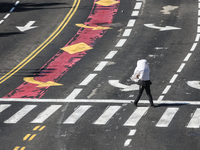 A person walks on a crosswalk on an empty street on Yom Kippur, the Jewish day of atonement and the holiest day in the Jewish calendar, amid...