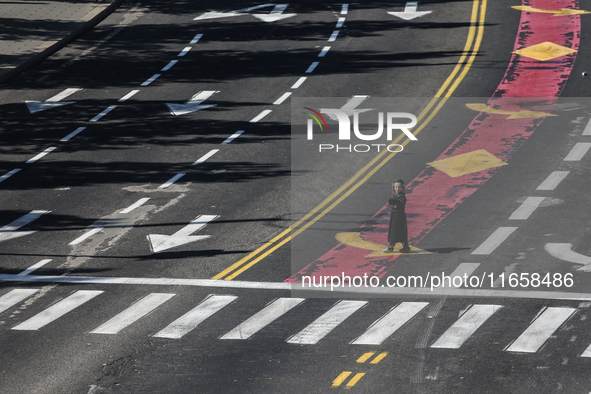 A person walks on a crosswalk on an empty street on Yom Kippur, the Jewish day of atonement and the holiest day in the Jewish calendar, amid...