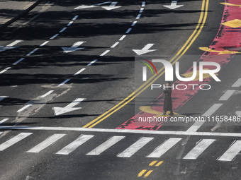 A person walks on a crosswalk on an empty street on Yom Kippur, the Jewish day of atonement and the holiest day in the Jewish calendar, amid...