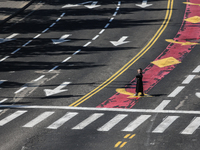 A person walks on a crosswalk on an empty street on Yom Kippur, the Jewish day of atonement and the holiest day in the Jewish calendar, amid...