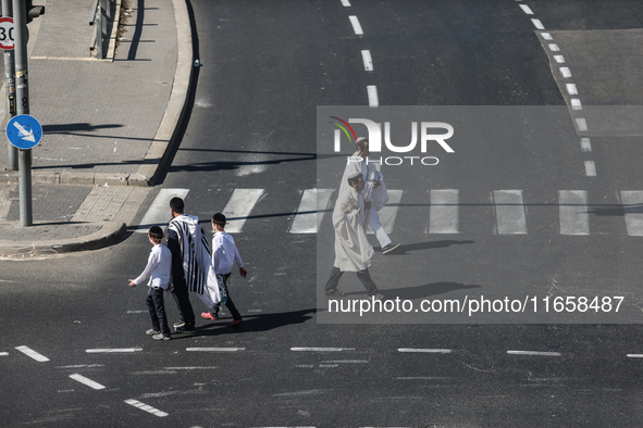 A person walks on a crosswalk on an empty street on Yom Kippur, the Jewish day of atonement and the holiest day in the Jewish calendar, amid...