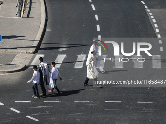 A person walks on a crosswalk on an empty street on Yom Kippur, the Jewish day of atonement and the holiest day in the Jewish calendar, amid...