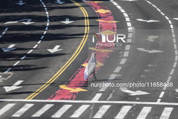 A person walks on a crosswalk on an empty street on Yom Kippur, the Jewish day of atonement and the holiest day in the Jewish calendar, amid...