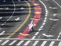 A person walks on a crosswalk on an empty street on Yom Kippur, the Jewish day of atonement and the holiest day in the Jewish calendar, amid...