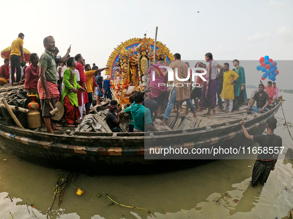 Maharaja Naba Krishna starts Durga Puja in 1757 at Sovabazar Royal Place. An idol of Goddess Durga is carried on a boat to the middle of the...