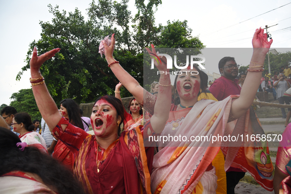 Indian Hindu devotees in traditional dress participate in the Hindu goddess Durga idol immersion in the River Ganges in Kolkata, India, on O...