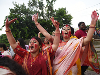 Indian Hindu devotees in traditional dress participate in the Hindu goddess Durga idol immersion in the River Ganges in Kolkata, India, on O...