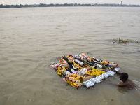 Hindu devotees immerse clay idols of Goddess Durga in the River Ganges in Kolkata, India, on October 12, 2024. The ten-day-long Hindu festiv...