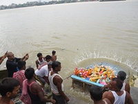 Hindu devotees immerse clay idols of Goddess Durga in the River Ganges in Kolkata, India, on October 12, 2024. The ten-day-long Hindu festiv...