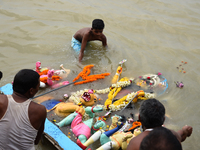 Hindu devotees immerse clay idols of Goddess Durga in the River Ganges in Kolkata, India, on October 12, 2024. The ten-day-long Hindu festiv...