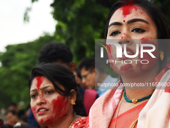 Hindu devotees cry during the immersion of the idol of Hindu goddess Durga on the banks of the river Ganges in Kolkata, India, on October 12...