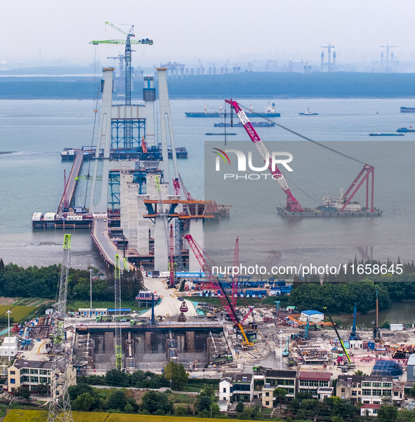 A photo taken on October 12, 2024, shows the construction site of the south main tower of the Zhangjinggao Yangtze River Bridge in Zhangjiag...