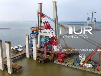 A photo taken on October 12, 2024, shows the construction site of the south main tower of the Zhangjinggao Yangtze River Bridge in Zhangjiag...