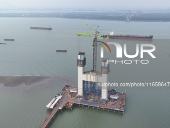 A photo taken on October 12, 2024, shows the construction site of the south main tower of the Zhangjinggao Yangtze River Bridge in Zhangjiag...