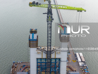 A photo taken on October 12, 2024, shows the construction site of the south main tower of the Zhangjinggao Yangtze River Bridge in Zhangjiag...