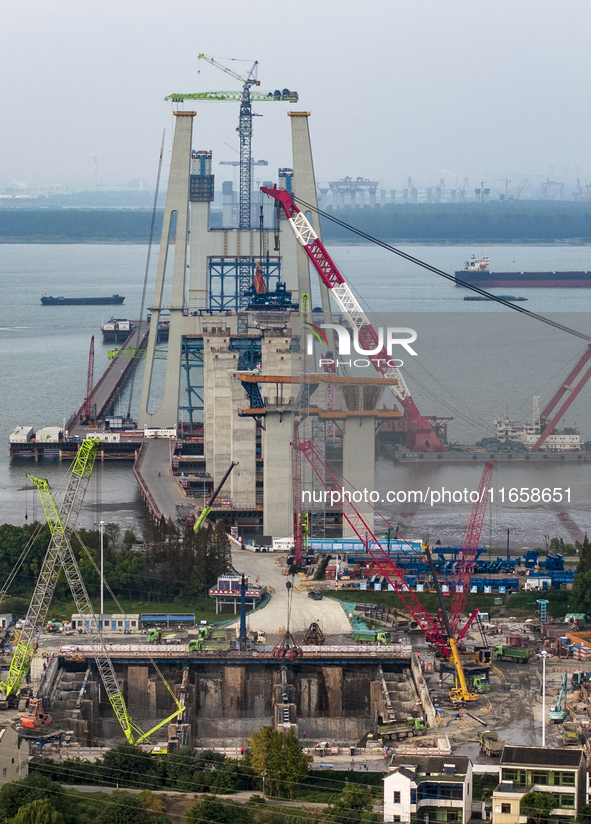 A photo taken on October 12, 2024, shows the construction site of the south main tower of the Zhangjinggao Yangtze River Bridge in Zhangjiag...