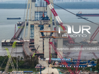 A photo taken on October 12, 2024, shows the construction site of the south main tower of the Zhangjinggao Yangtze River Bridge in Zhangjiag...