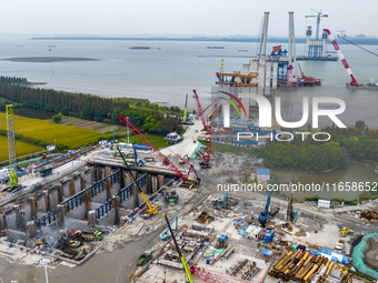 A photo taken on October 12, 2024, shows the construction site of the south main tower of the Zhangjinggao Yangtze River Bridge in Zhangjiag...