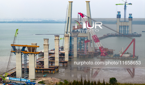 A photo taken on October 12, 2024, shows the construction site of the south main tower of the Zhangjinggao Yangtze River Bridge in Zhangjiag...