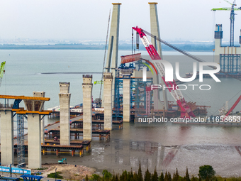 A photo taken on October 12, 2024, shows the construction site of the south main tower of the Zhangjinggao Yangtze River Bridge in Zhangjiag...