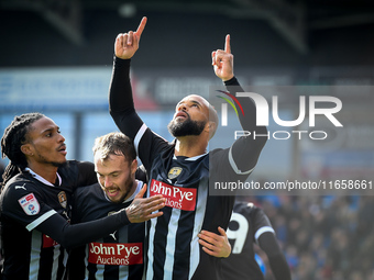 David McGoldrick of Notts County celebrates with teammates after scoring a goal to make it 2-2 during the Sky Bet League 2 match between Che...