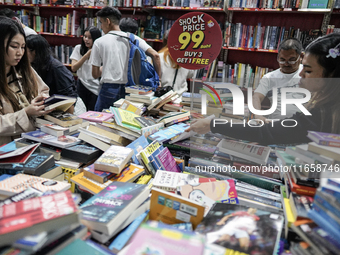 Visitors check discounted books at the Book Expo Thailand 2024 in Bangkok, Thailand, on October 12, 2024. The Book Expo Thailand 2024 takes...