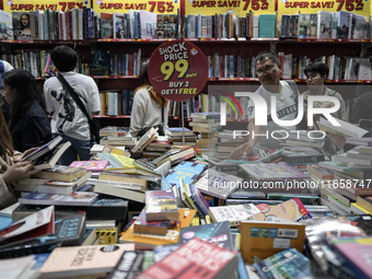 Visitors check discounted books at the Book Expo Thailand 2024 in Bangkok, Thailand, on October 12, 2024. The Book Expo Thailand 2024 takes...