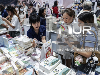 Visitors check books on display during the Book Expo Thailand 2024 in Bangkok, Thailand, on October 12, 2024. The Book Expo Thailand 2024 ta...