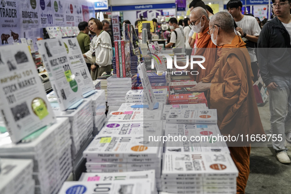 A Thai Buddhist monk and visitors check books on display during the Book Expo Thailand 2024 in Bangkok, Thailand, on October 12, 2024. The B...