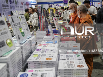 A Thai Buddhist monk and visitors check books on display during the Book Expo Thailand 2024 in Bangkok, Thailand, on October 12, 2024. The B...