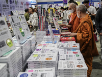 A Thai Buddhist monk and visitors check books on display during the Book Expo Thailand 2024 in Bangkok, Thailand, on October 12, 2024. The B...