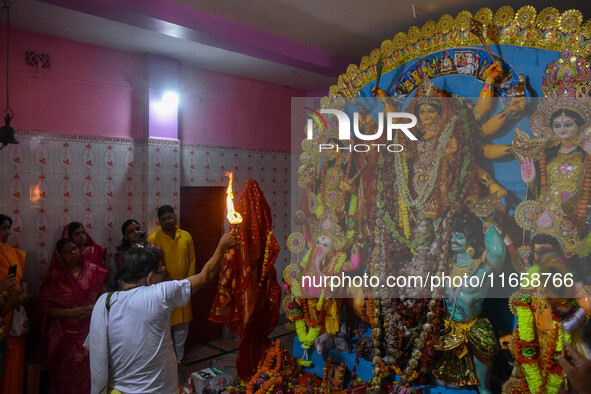 A priest worships an idol of goddess Durga on the last day of the Durga Puja festival in Kolkata, India, on October 12, 2024. 