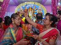 Married females smear each other with vermillion during a ritual called the vermillion game or ''Sindur Khela'' during the last day of the D...