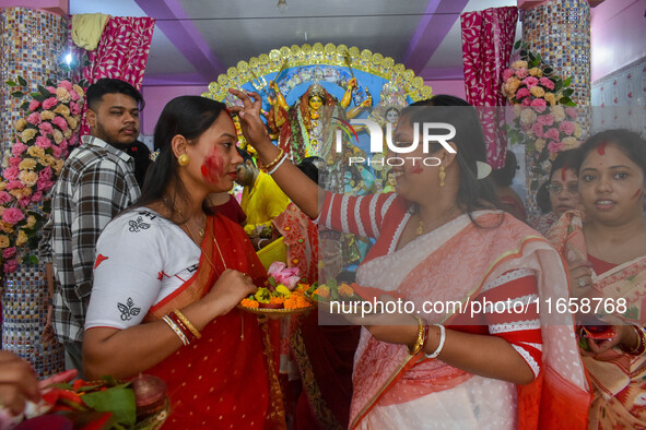 Married females smear each other with vermillion during a ritual called the vermillion game or ''Sindur Khela'' during the last day of the D...