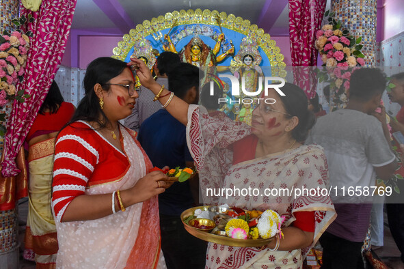 Married females smear each other with vermillion during a ritual called the vermillion game or ''Sindur Khela'' during the last day of the D...