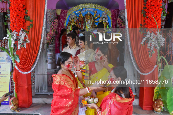 Married females smear each other with vermillion during a ritual called the vermillion game or ''Sindur Khela'' during the last day of the D...