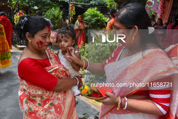 Married females smear each other with vermillion during a ritual called the vermillion game or ''Sindur Khela'' during the last day of the D...