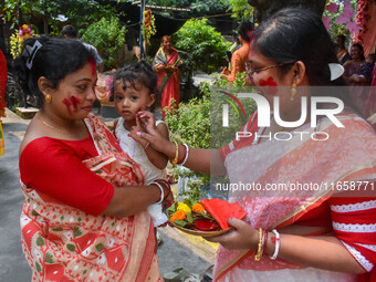 Married females smear each other with vermillion during a ritual called the vermillion game or ''Sindur Khela'' during the last day of the D...