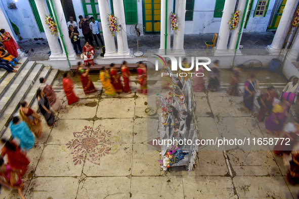 Married women offer their prayers for the last time to goddess Durga and immerse themselves in the ritual of ''Sindur Khela'' or vermillion...