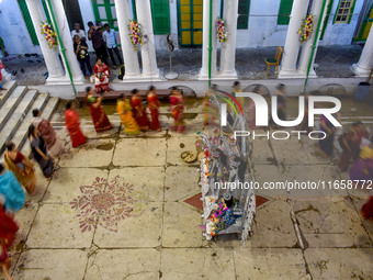 Married women offer their prayers for the last time to goddess Durga and immerse themselves in the ritual of ''Sindur Khela'' or vermillion...