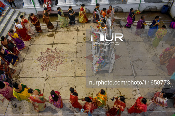 Married women offer their prayers for the last time to goddess Durga and immerse themselves in the ritual of ''Sindur Khela'' or vermillion...