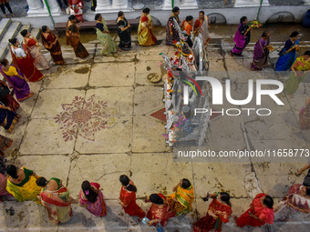 Married women offer their prayers for the last time to goddess Durga and immerse themselves in the ritual of ''Sindur Khela'' or vermillion...