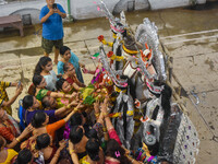 Married women offer their prayers for the last time to goddess Durga and immerse themselves in the ritual of ''Sindur Khela'' or vermillion...