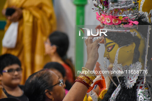 Married women offer their prayers for the last time to goddess Durga and immerse themselves in the ritual of ''Sindur Khela'' or vermillion...