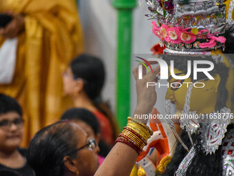 Married women offer their prayers for the last time to goddess Durga and immerse themselves in the ritual of ''Sindur Khela'' or vermillion...