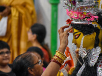 Married women offer their prayers for the last time to goddess Durga and immerse themselves in the ritual of ''Sindur Khela'' or vermillion...