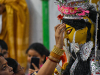 Married women offer their prayers for the last time to goddess Durga and immerse themselves in the ritual of ''Sindur Khela'' or vermillion...