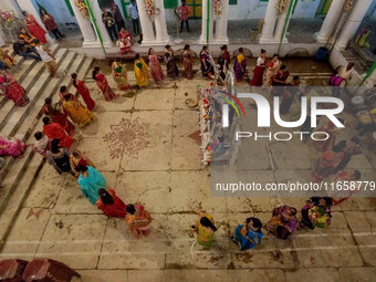 Married women offer their prayers for the last time to goddess Durga and immerse themselves in the ritual of ''Sindur Khela'' or vermillion...