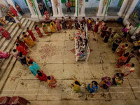 Married women offer their prayers for the last time to goddess Durga and immerse themselves in the ritual of ''Sindur Khela'' or vermillion...